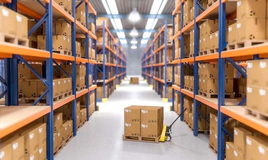 Warehouse aisle with pallet racking stacked with cardboard boxes