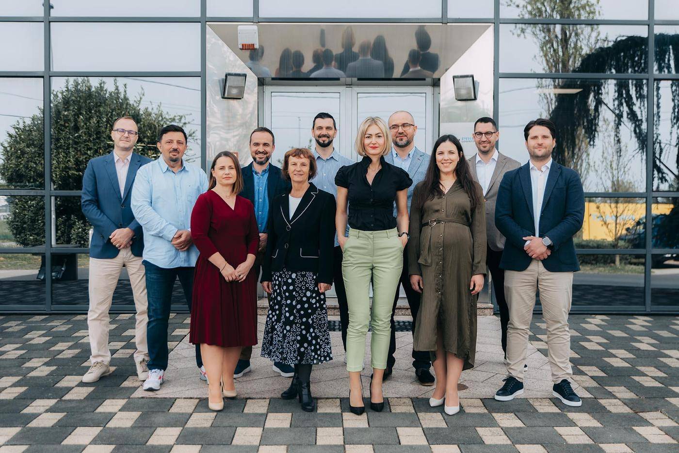 The DTA Logistics team standing together outside their office
